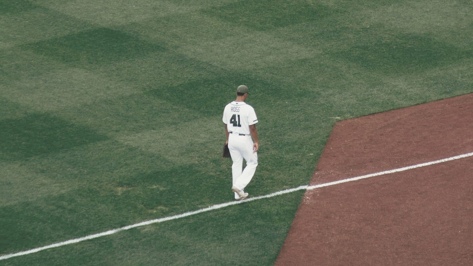 A baseball player at bat in a batting cage