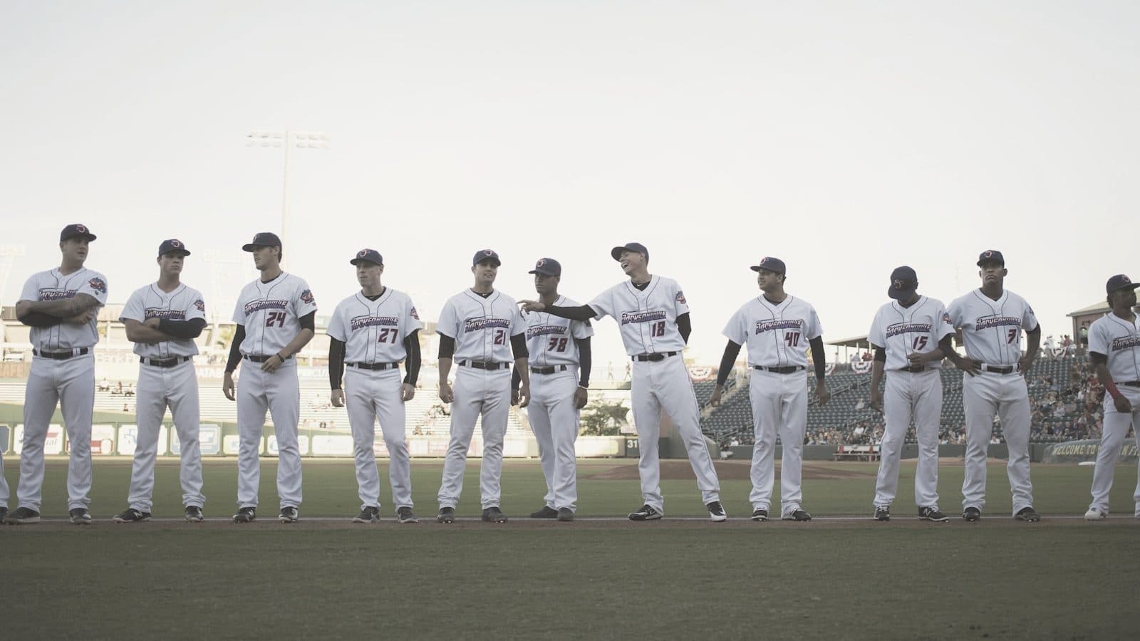 A baseball team lined up along the baseline before a game