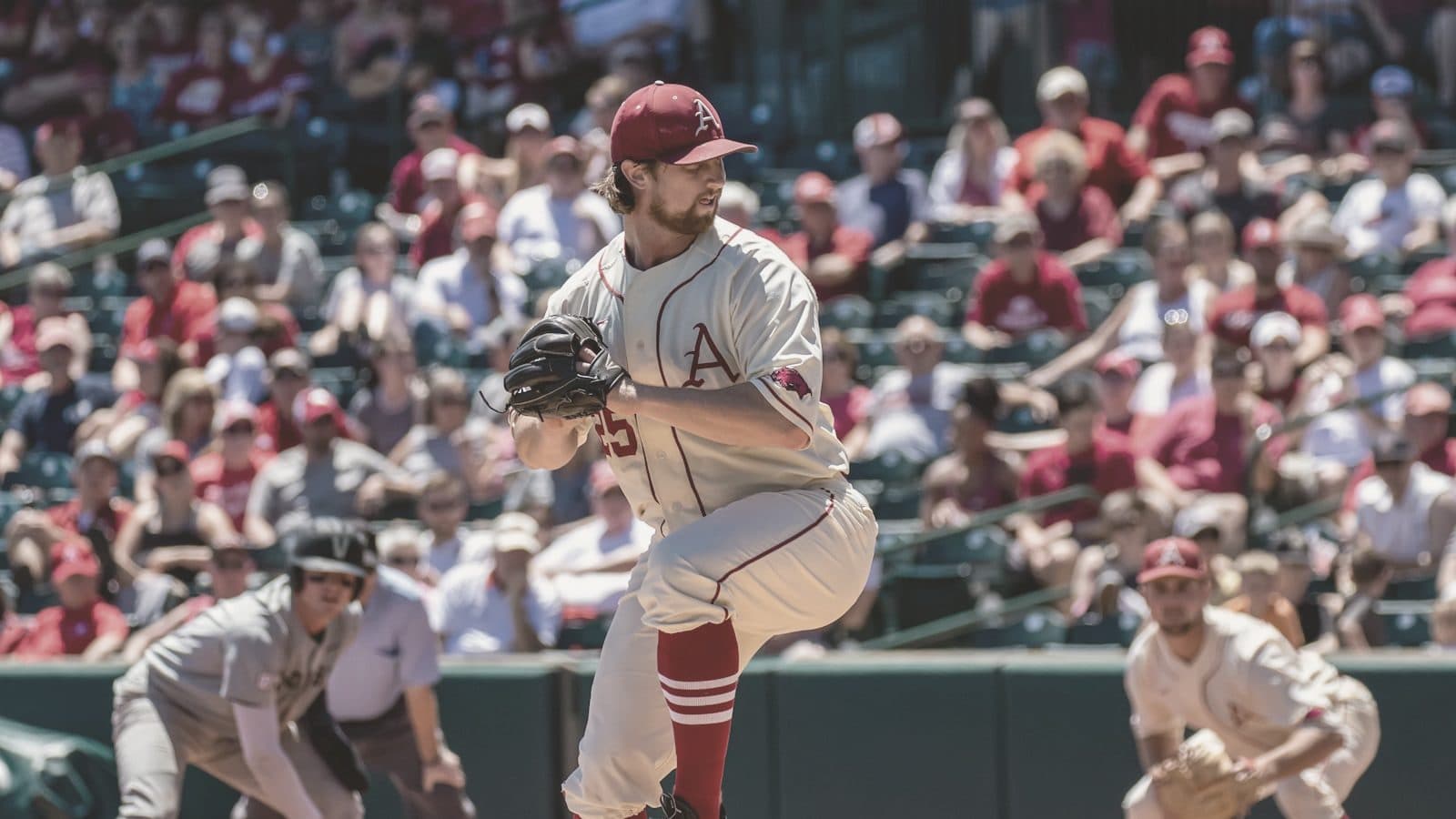 A pitcher gripping a baseball