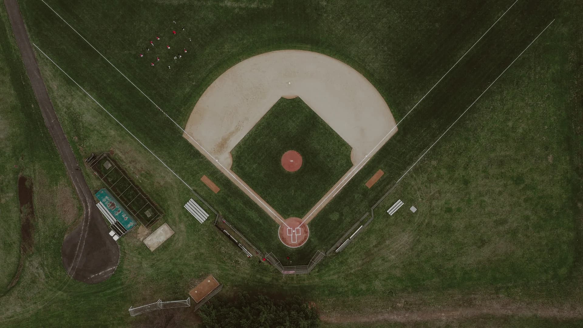 An aerial view of a baseball diamond surrounded by green fields